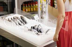 woman shopping for fish in a supermarket