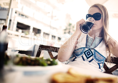 woman enjoying a dark beer with her meal