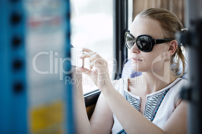 woman taking pictures at her mobile on a bus