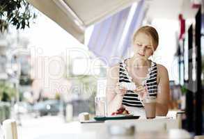 attractive woman taking picture of a pastry on her mobile