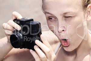 woman pulling a comical face as she views in the viewfinder