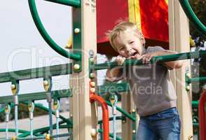 boy on playground equipment.