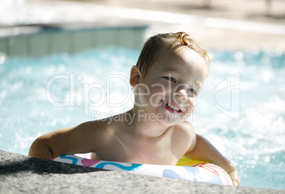 kid learns to swim using a plastic water ring