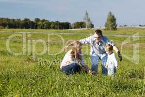 protective father playing with his wife and son