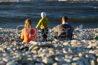 family of three on pebble beach