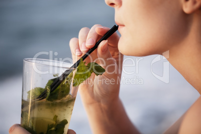 close up of woman enjoying an evening cocktail