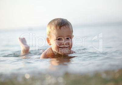 smiling little boy in the sea