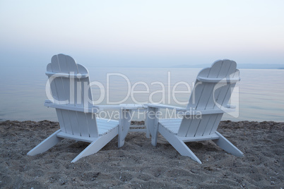 empty wooden deck chairs on a beach