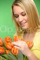 woman looking down spring flowers orange tulips