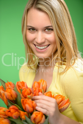 smiling woman hold spring  flowers orange tulip