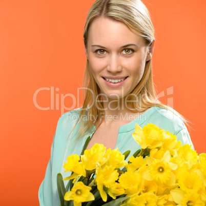 spring woman hold yellow narcissus flowers