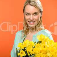 spring woman hold yellow narcissus flowers