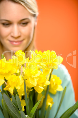 woman with spring yellow flower narcissus