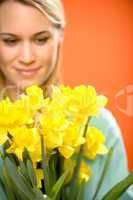 woman with spring yellow flower narcissus