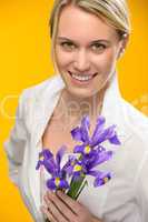 woman hold one spring iris flower smiling