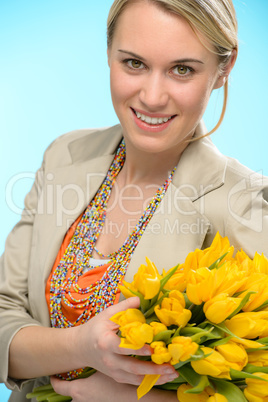 woman with spring flowers yellow tulips