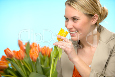 woman smelling one yellow tulip spring flowers