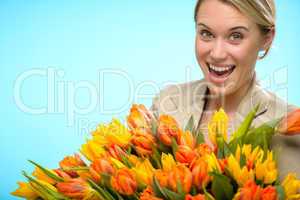 cheerful woman with colorful spring tulips