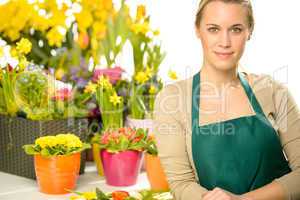 florist with spring potted flowers