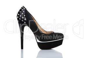 Black platform shoe with studs, isolated on white