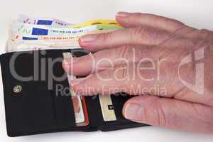 hand reaching for wallet with banknotes