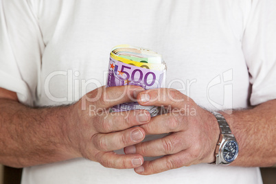 hand holding glass with paper money