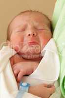 Cute sleeping newborn baby child on mother hands