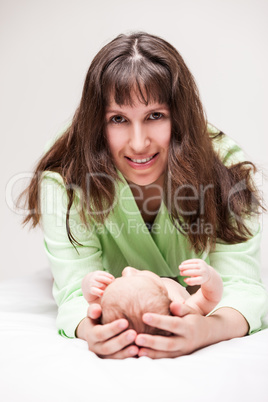 Cute sleeping newborn baby child on mother hands