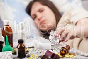 Unwell woman patient lying down bed