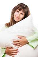 Beauty smiling woman holding pillow for rest and sleep