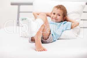 Little child boy with plaster bandage on leg heel fracture or br