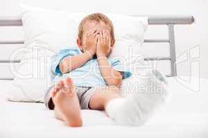 Little child boy with plaster bandage on leg heel fracture or br