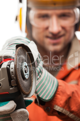 Engineer or manual worker man in safety hardhat helmet holding a