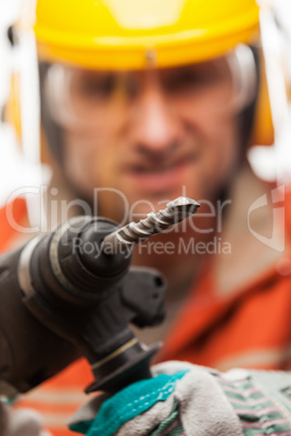 Engineer or manual worker man in safety hardhat helmet holding h
