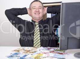 businessman is pleased with his money on the desk
