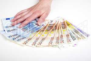 hand fans out euro bills