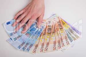 hand fans out euro bills