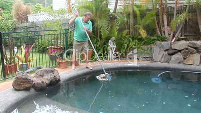 man cleaning pool