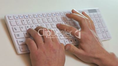 angry businessman typing on a keyboard