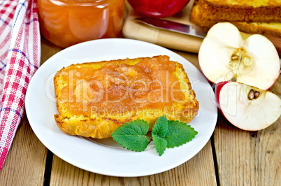 Bread with apple jam and apple on a board