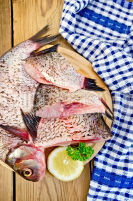 Bream raw on board with a knife and napkin