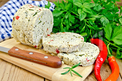 Cheese homemade with hot peppers on board with knife