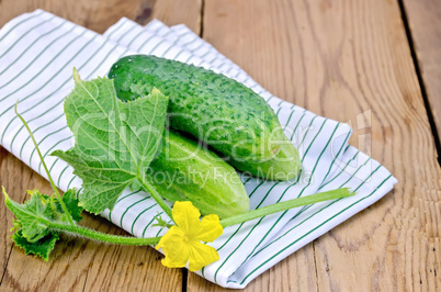 Cucumber with flower and doily on the board