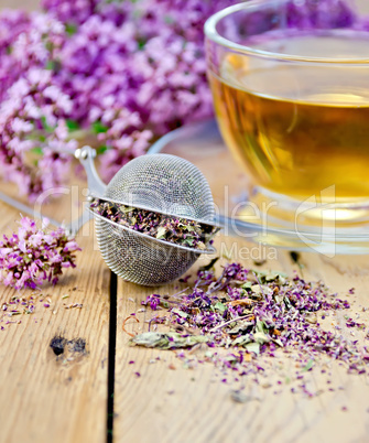 Herbal tea from oregano with strainer on board