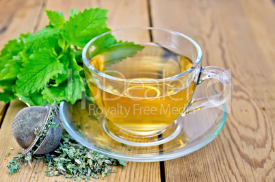 Herbal tea with melissa in a cup and strainer