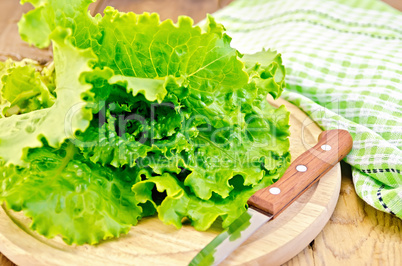 Lettuce green with knife and napkin on a board