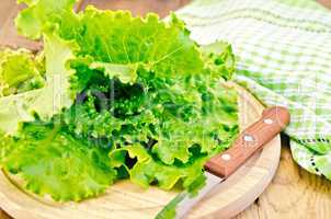 Lettuce green with knife and napkin on a board