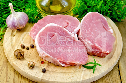 Meat pork slices on a board with nutmeg