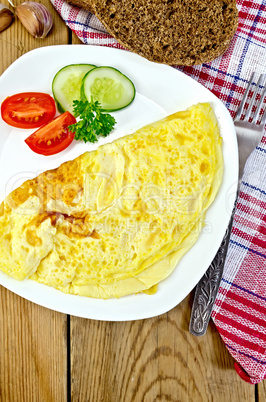 Omelet with vegetables and bread on the board