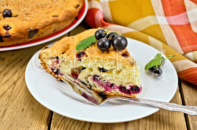pie with black currant on the board with a fork
